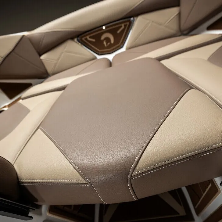 Close-up view of a modern boat seat with beige and brown leather upholstery and geometric stitching patterns.