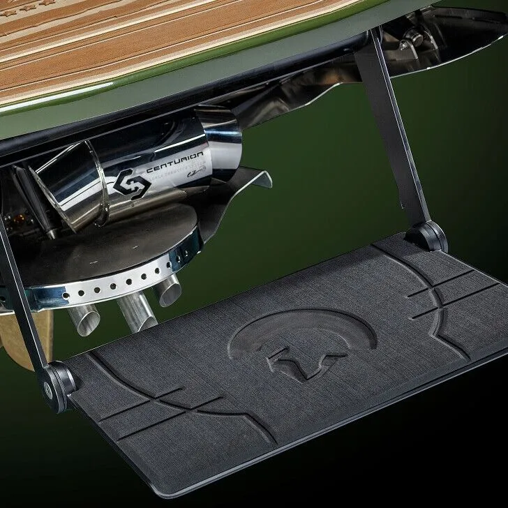 Close-up view of a boat's onboard mechanical components, including a Centurion exhaust system and a textured platform with a Spartan helmet logo.