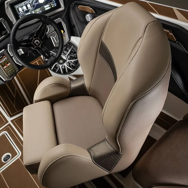 Close-up view of a modern boat cockpit featuring a leather captain's chair, a steering wheel, and dashboard controls with brown and beige interior accents.