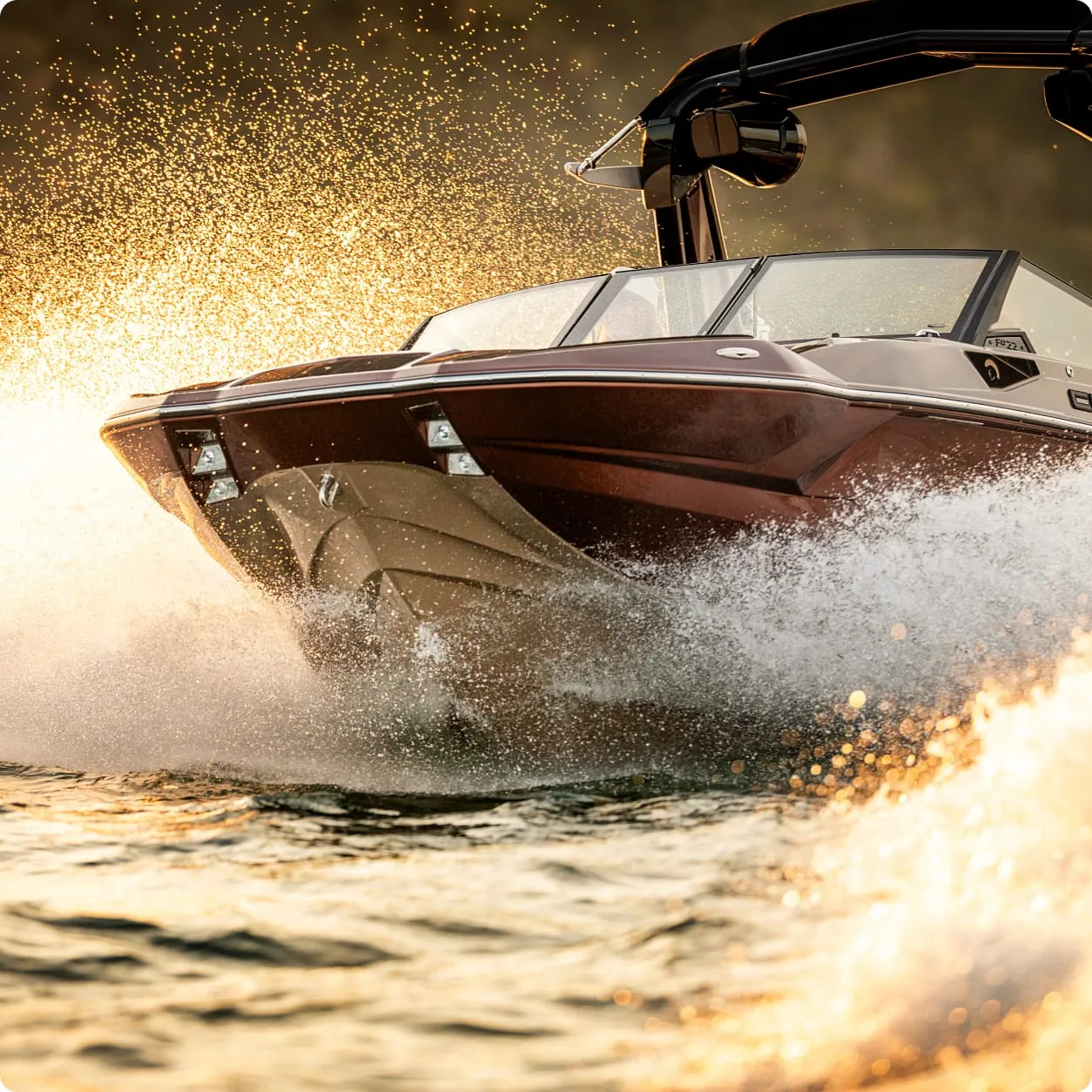 A speedboat with a Centurion Opti-V Hull moves quickly across the water, creating splashes and sunlight reflections around the hull.