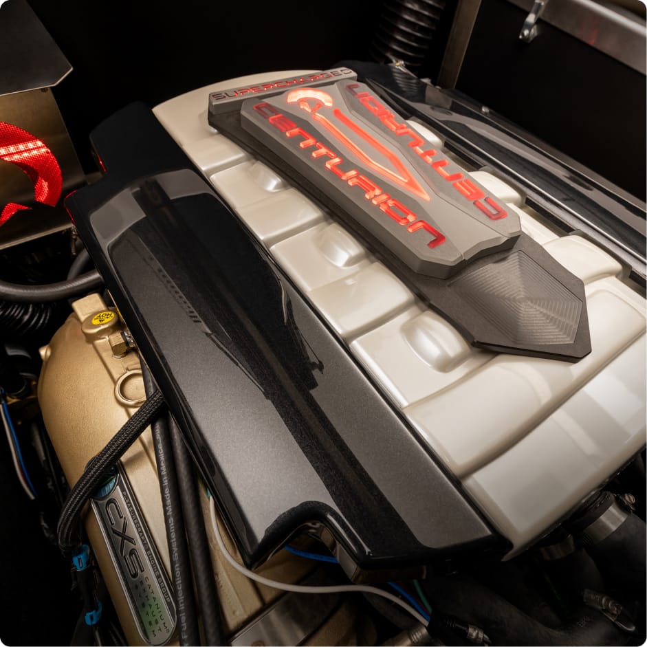 Close-up view of a Centurion engine with visible branding and detailed components under the hood, showcasing the engineering behind Centurion boat fuel efficiency.