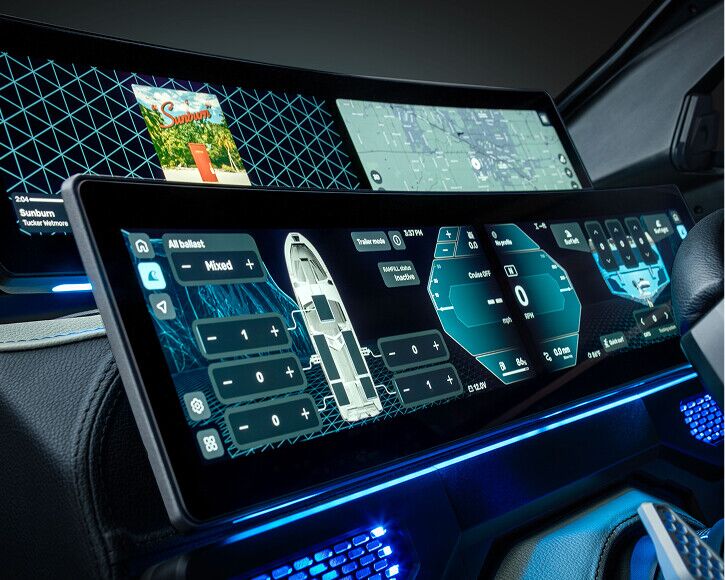 Close-up of a futuristic car dashboard with multiple digital screens displaying vehicle controls, navigation map, and media information—design elements inspired by the innovative technology found in Centurion NV Series surf boats. Blue ambient lighting illuminates the interior, echoing the sophisticated atmosphere of NV Series Wake Boats.