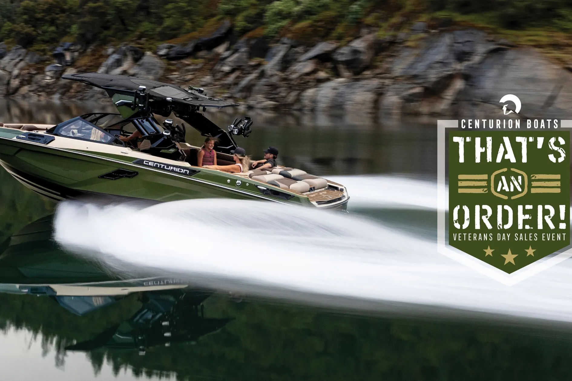 A green Centurion speedboat moves quickly across a calm lake with several people on board; a Veterans Day sales event graphic appears on the right.