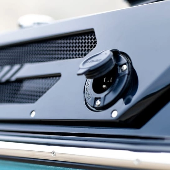 Close-up view of an electric charging port on a dark-colored Ri Series vehicle, with the port cover flipped open—showcasing Features Personal convenience and advanced electric innovation.