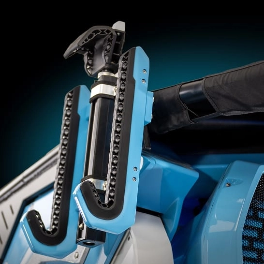 Close-up of a blue and black Ri Series mechanical device attached to a larger machine, featuring a cylindrical component and chain-like elements with personalized features.
