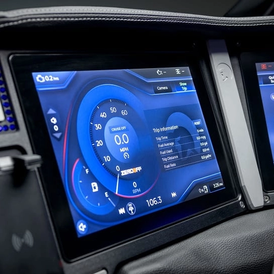 Close-up of a Ri Series vehicle's digital dashboard display, featuring Personal settings for speedometer, trip information, fuel level, and radio station.