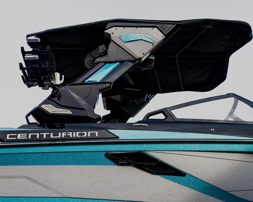 Close-up of a blue and gray Centurion boat featuring a folded black Bimini top, visible branding on the side, and sleek Centurion Towers overhead.
