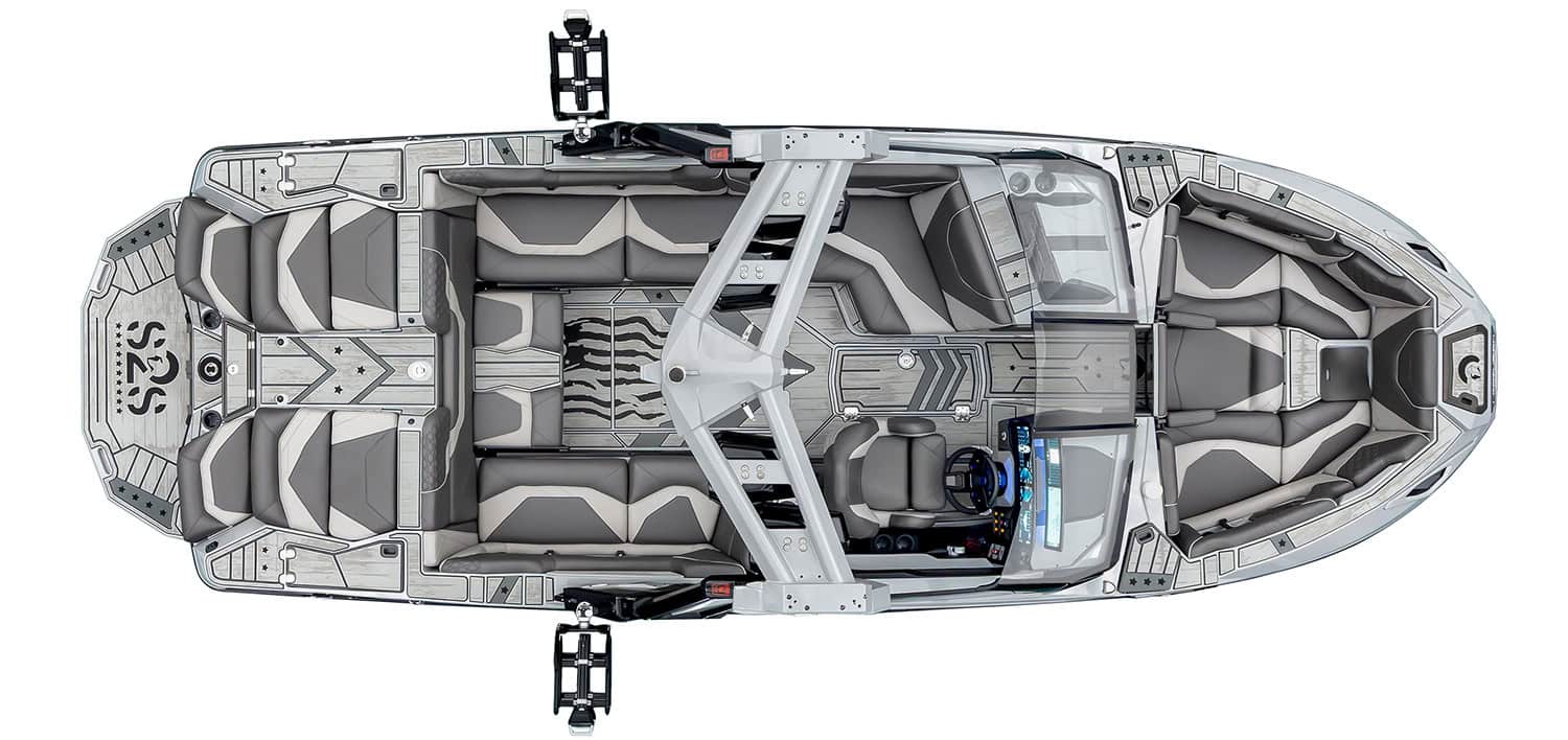 Top-down view of a modern gray wakeboard boat with seating, a central tower, and wakeboard racks on each side.