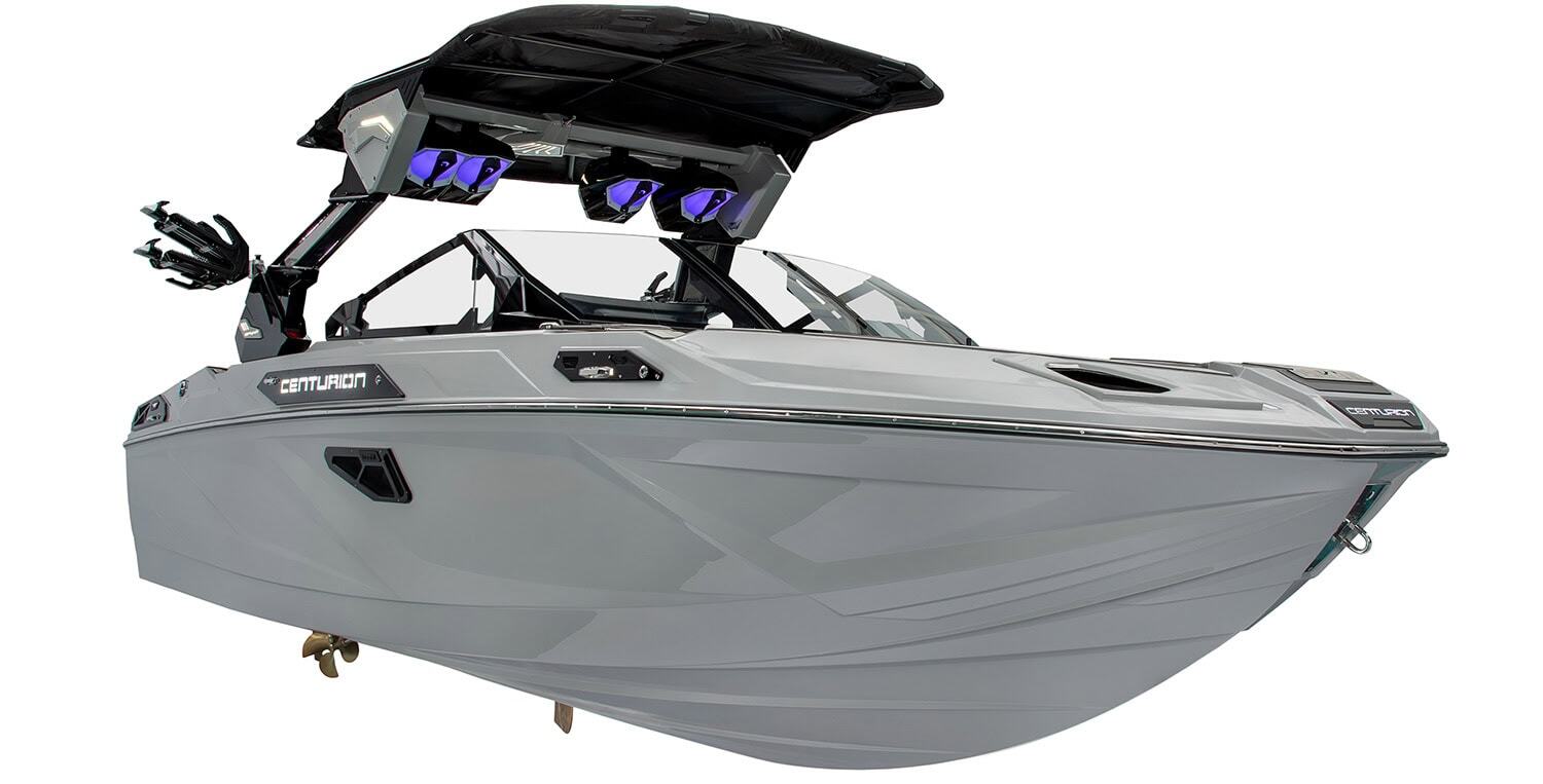 A modern gray wakeboard boat with a black wakeboard tower, speakers, and multiple seating areas, viewed from the front left side against a white background.