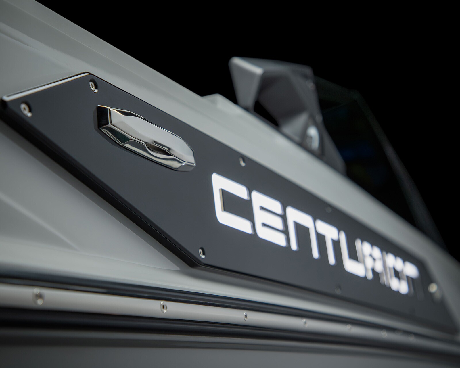 Close-up view of a boat's side, featuring a metallic handle and illuminated
