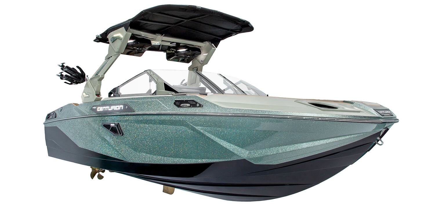 A modern, metallic teal Centurion motorboat with a black canopy and a sleek hull, photographed against a white background.