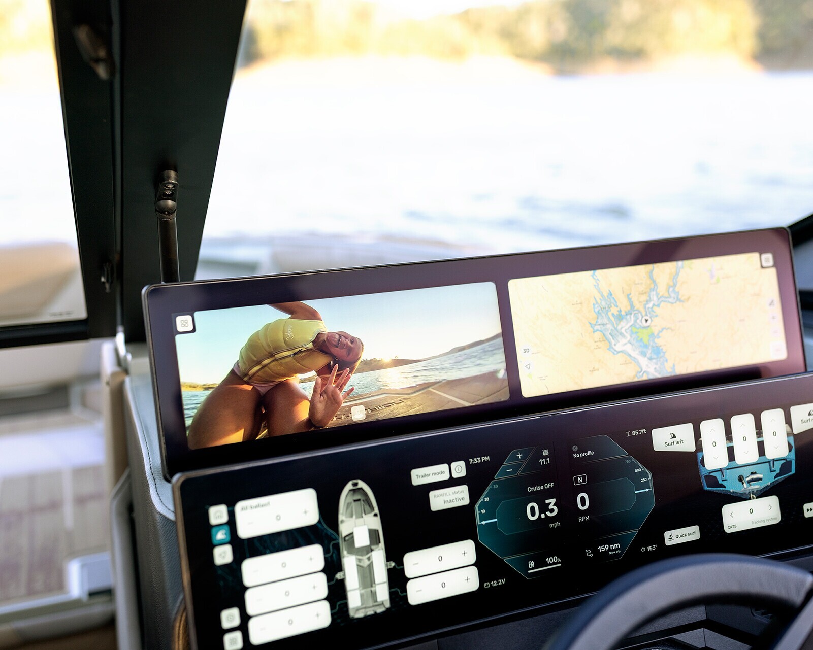Boat dashboard displays navigation data, controls, a map, and a live camera feed showing a person in a yellow life jacket near the water.