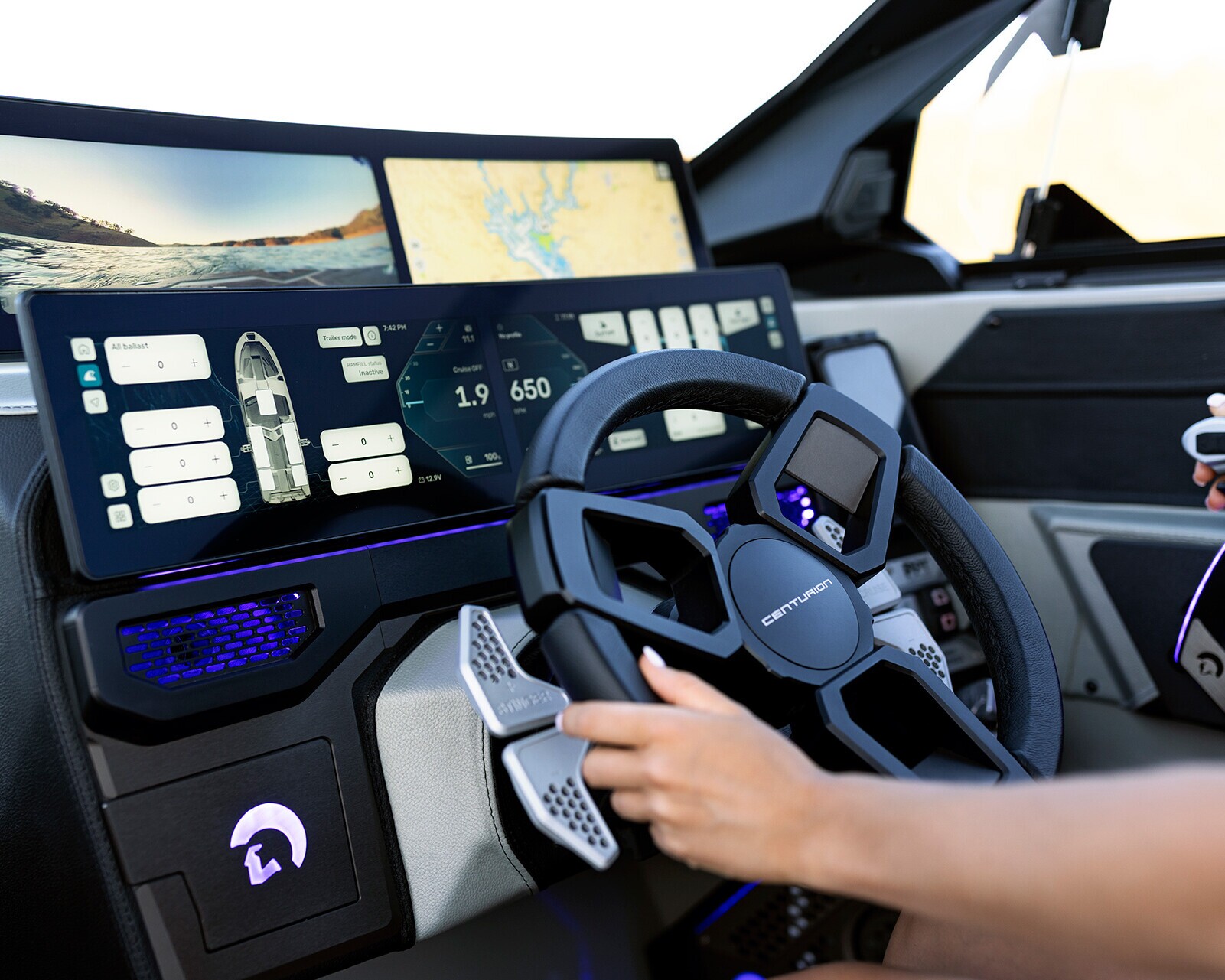Person operating a modern boat control panel with digital navigation screens, a steering wheel, and throttle controls.