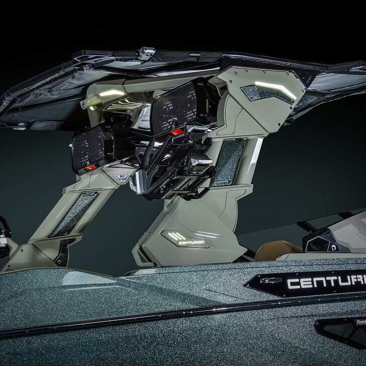 Close-up of a futuristic boat cockpit with dual control panels, angular metallic surfaces, LED accent lighting, and the word 