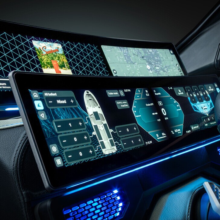 Close-up of a futuristic car dashboard display showing navigation maps, vehicle status, and control panels with blue lighting accents.