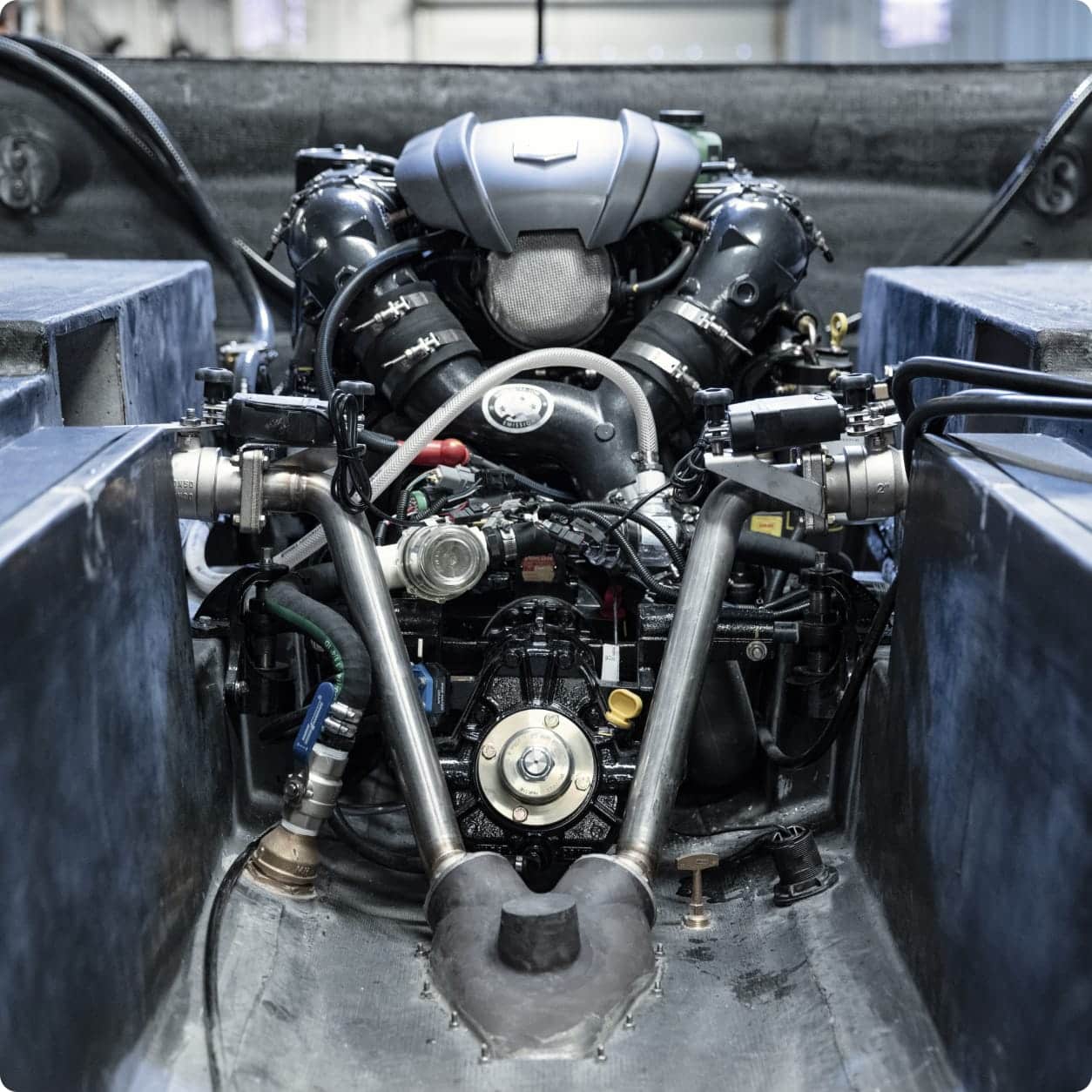 Close-up view of a Centurion RAMFILL engine mounted inside a vehicle chassis, showing various pipes, wires, and mechanical components in an industrial setting.