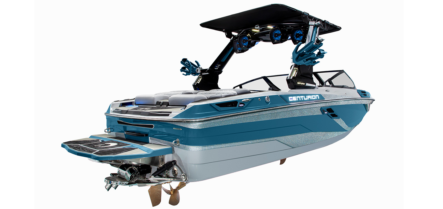 A blue and silver Centurion Ri230 wakeboard boat with a black tower, multiple speakers, seating, and Centurion branding, viewed from the rear and side against a white background.
