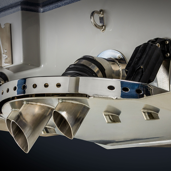 Close-up view of a Ri Series boat’s dual exhaust system and related components mounted on the stern, highlighting polished metal pipes, mechanical fittings, and personalized features.