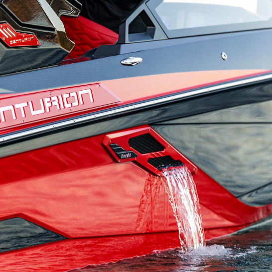 A close-up of a red and black Centurion Ri Series boat showcases water flowing out of a side vent, highlighting its distinctive Features Personal.