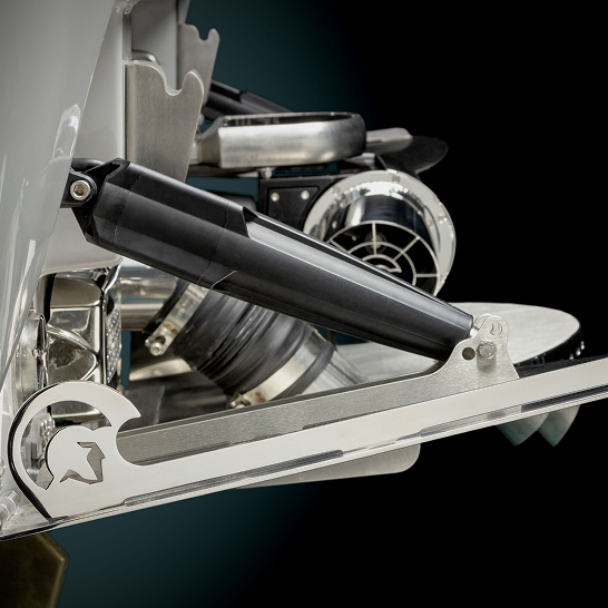 Close-up view of a Ri Series metal boat trim tab system, showcasing its polished components and hydraulic actuators—highlighting features personal to the design against a sleek black background.
