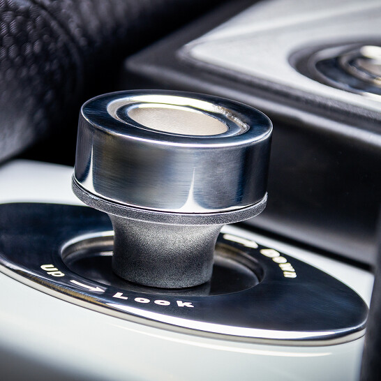 Close-up of a metallic Nv Series car gear selector knob with 
