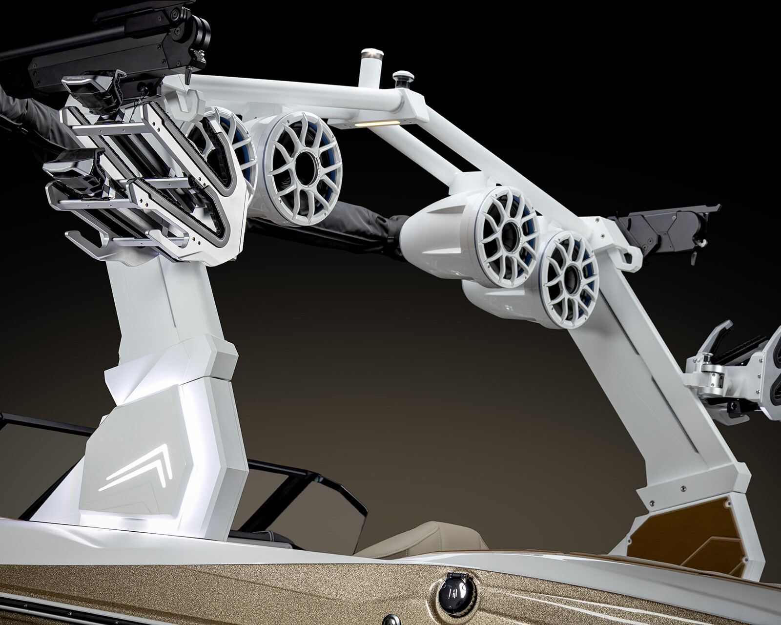 Close-up view of a Centurion Nv213 wakeboard tower featuring mounted speakers, racks for boards, and integrated lighting, set against a dark gradient background.