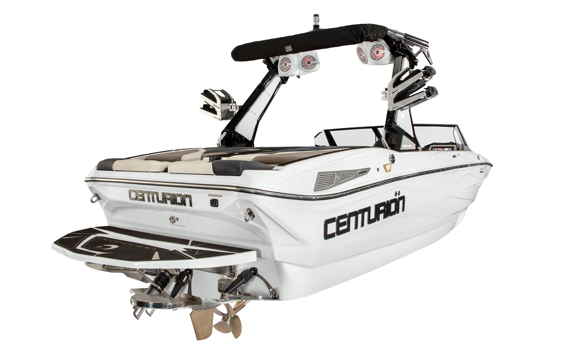 A white Centurion Nv213 Wake Boat with black trim, wakeboard tower, and mounted speakers is seen from the rear left, featuring a visible swim platform and propellers.