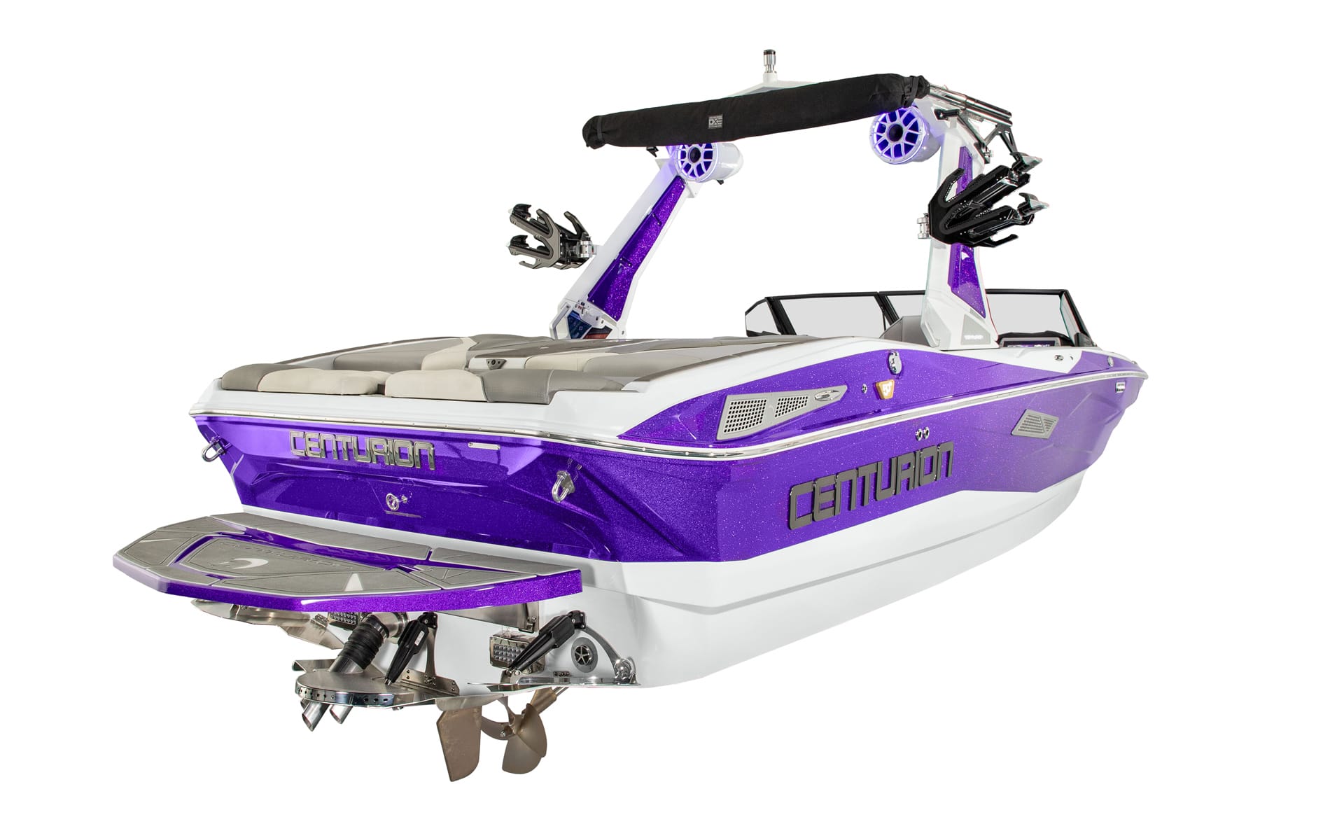 A purple and white Centurion Nv233 speedboat with seating, wakeboard racks, speakers, and dual propellers, viewed from the rear and side on a white background.