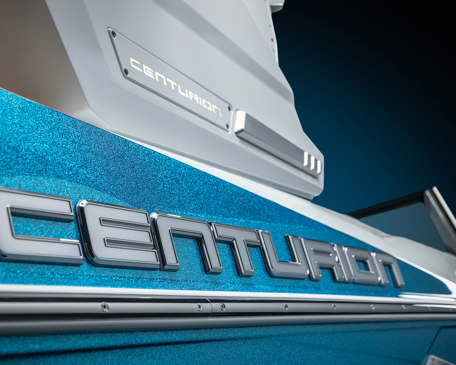 Close-up of a blue Centurion Nv243 wake boat with metallic