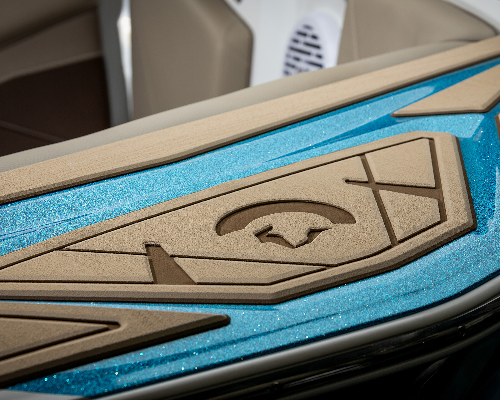 Close-up of a Centurion Nv243 Surf Boat’s blue and tan textured deck padding with geometric patterns and a star and crescent moon design.