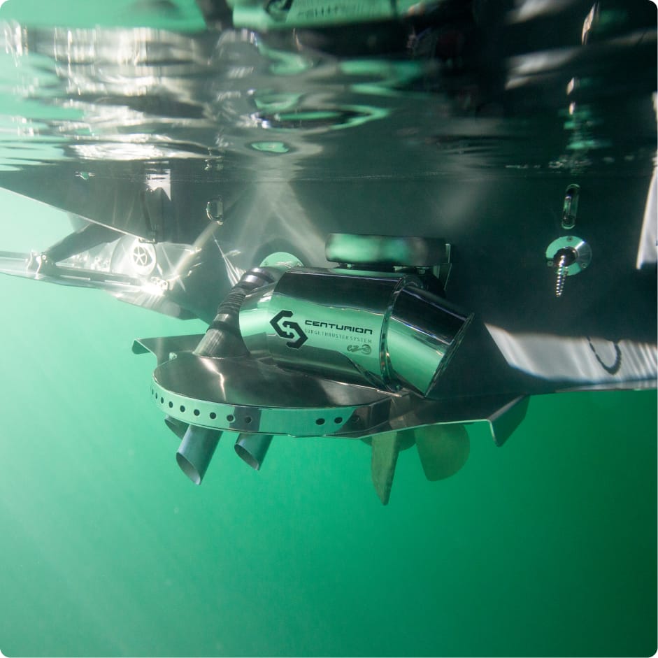 A close-up underwater view of a Centurion exhaust system installed on a boat with the Centurion Opti-V Hull, showing the propeller and surrounding hardware.