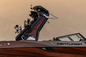 Side view of a Centurion speedboat with a metallic brown finish, showing a tower with mounted equipment against a neutral background.