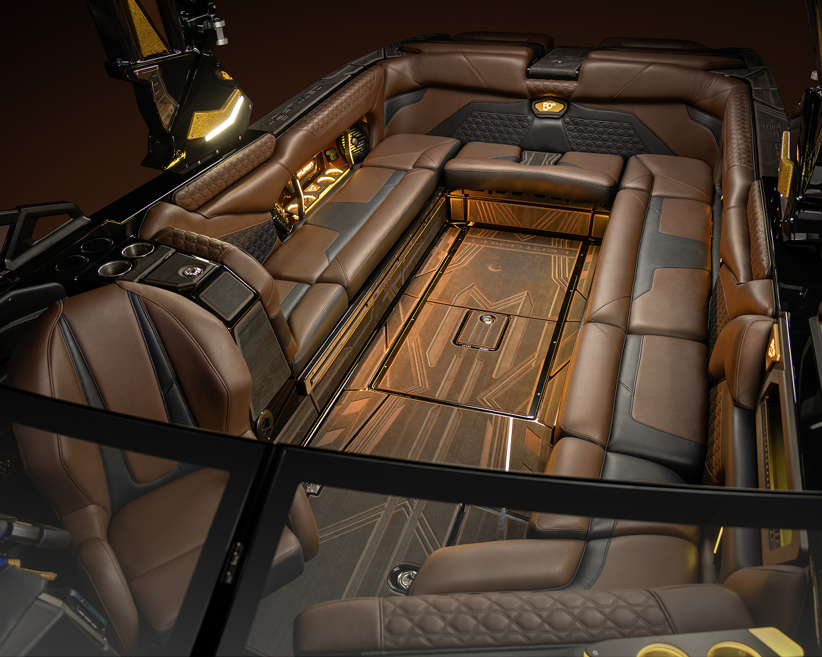 Luxurious Centurion Ri230 interior with brown leather seating, wood accents, cup holders, and ambient lighting, viewed from above.