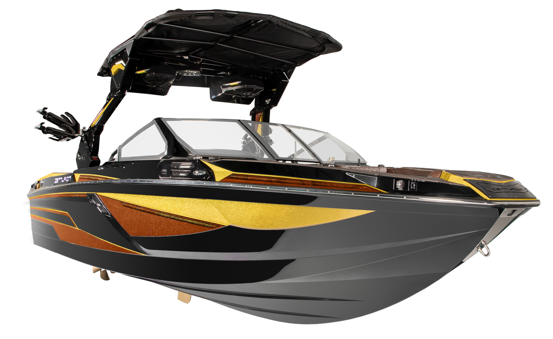 Black and gold Centurion Ri230 Wake Boat with a covered cockpit, tinted windshield, and mounted wakeboard racks, shown against a white background.