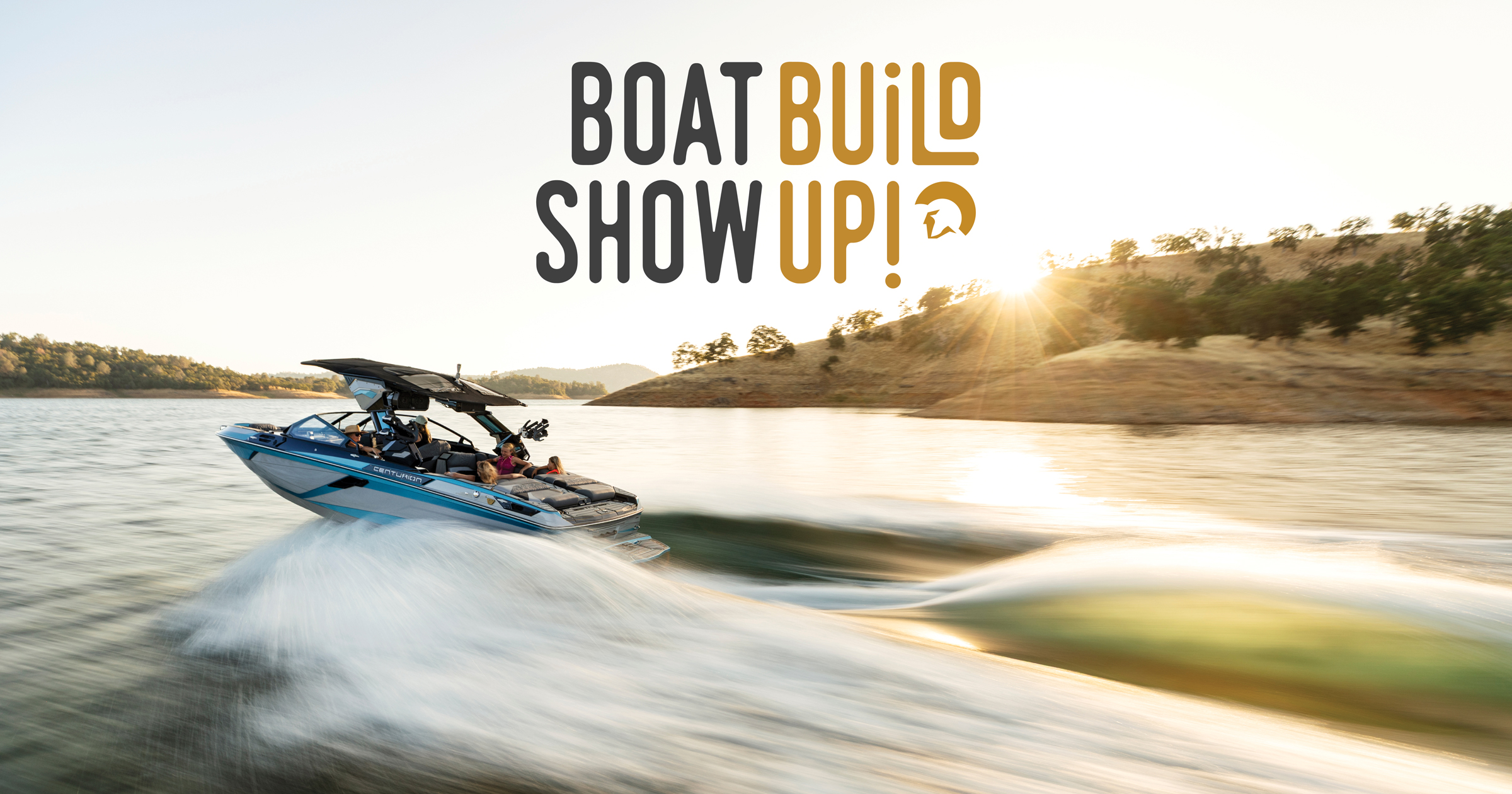 A speedboat moves quickly across a lake with two people on board; sun shines over a hilly shoreline. Text above reads "Boat Build Show Up!.