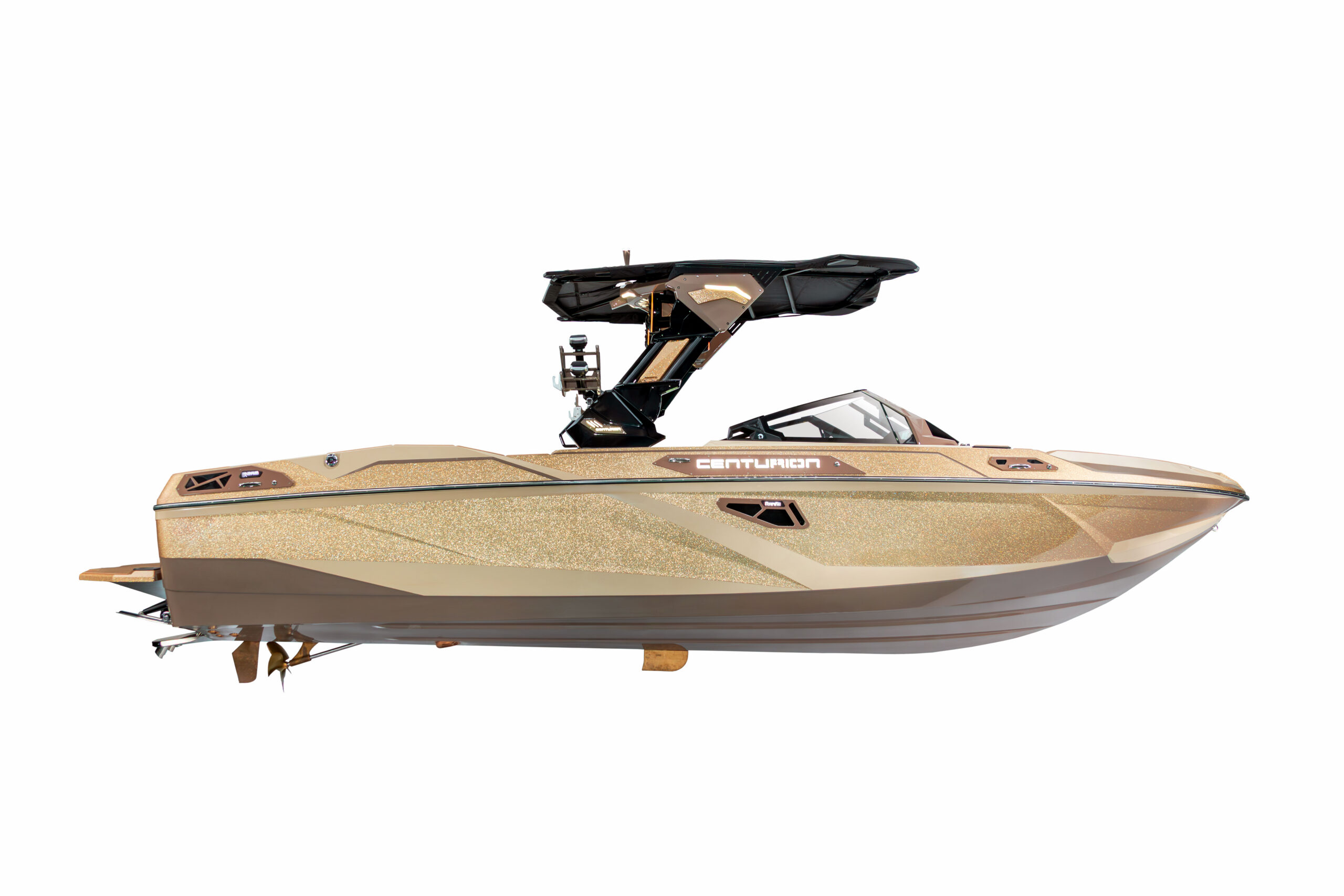 Beige and gold Centurion speedboat with black wakeboard tower, isolated on a white background, side view.